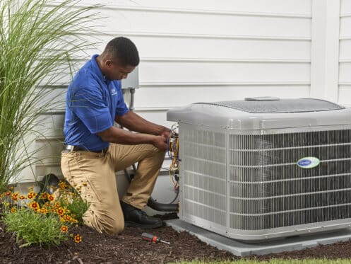 service man fixing ac unit