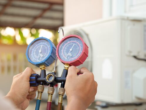 HVAC tech checking refrigerant pressure